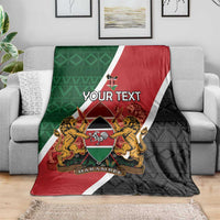 Personalised Kenya blanket on sofa; red and black front with green panel, diagonal flag border, coat of arms