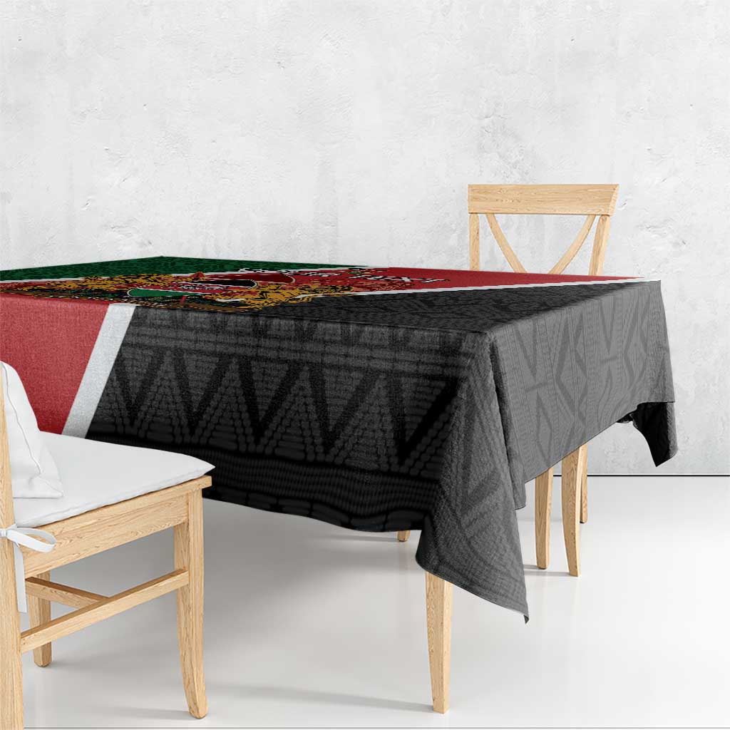 Kenya tablecloth draped over table, black textured pattern with red/green diagonal panel.