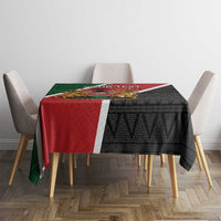 Kenya tablecloth on dining table, red and green sections with black geometric pattern.