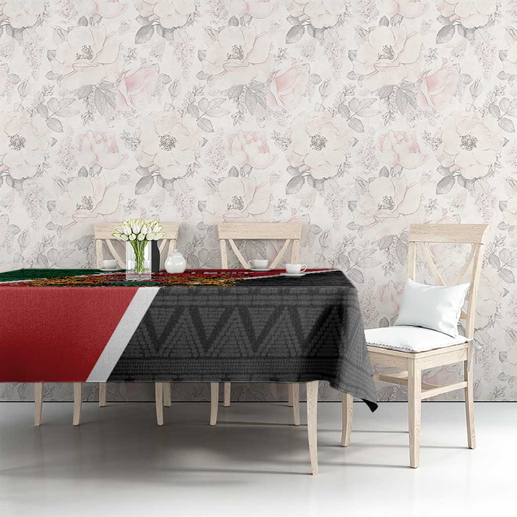 Kenya tablecloth on dining table, black geometric design with red and green corner stripe.