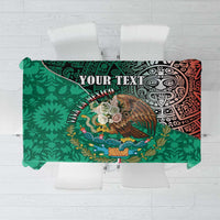 Green tablecloth featuring central eagle graphic and red Aztec-style design, flat view