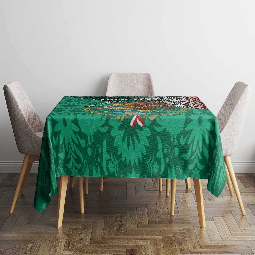Green printed tablecloth with leaf shapes and small red accents, laid on dining table