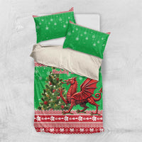 Green Christmas bedding set laid flat: dragon duvet cover with two pillowcases, snowflakes