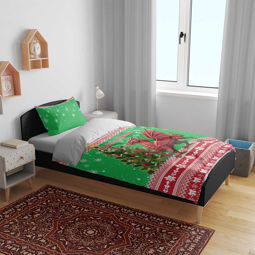 Green Christmas bedding set on bed: red dragon and snowflake print duvet with two pillowcases