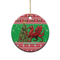 Green round ceramic Christmas ornament featuring a red Welsh dragon design.