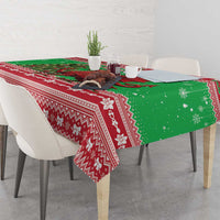 Green holiday tablecloth with red patterned stripes and dragon graphic on corner