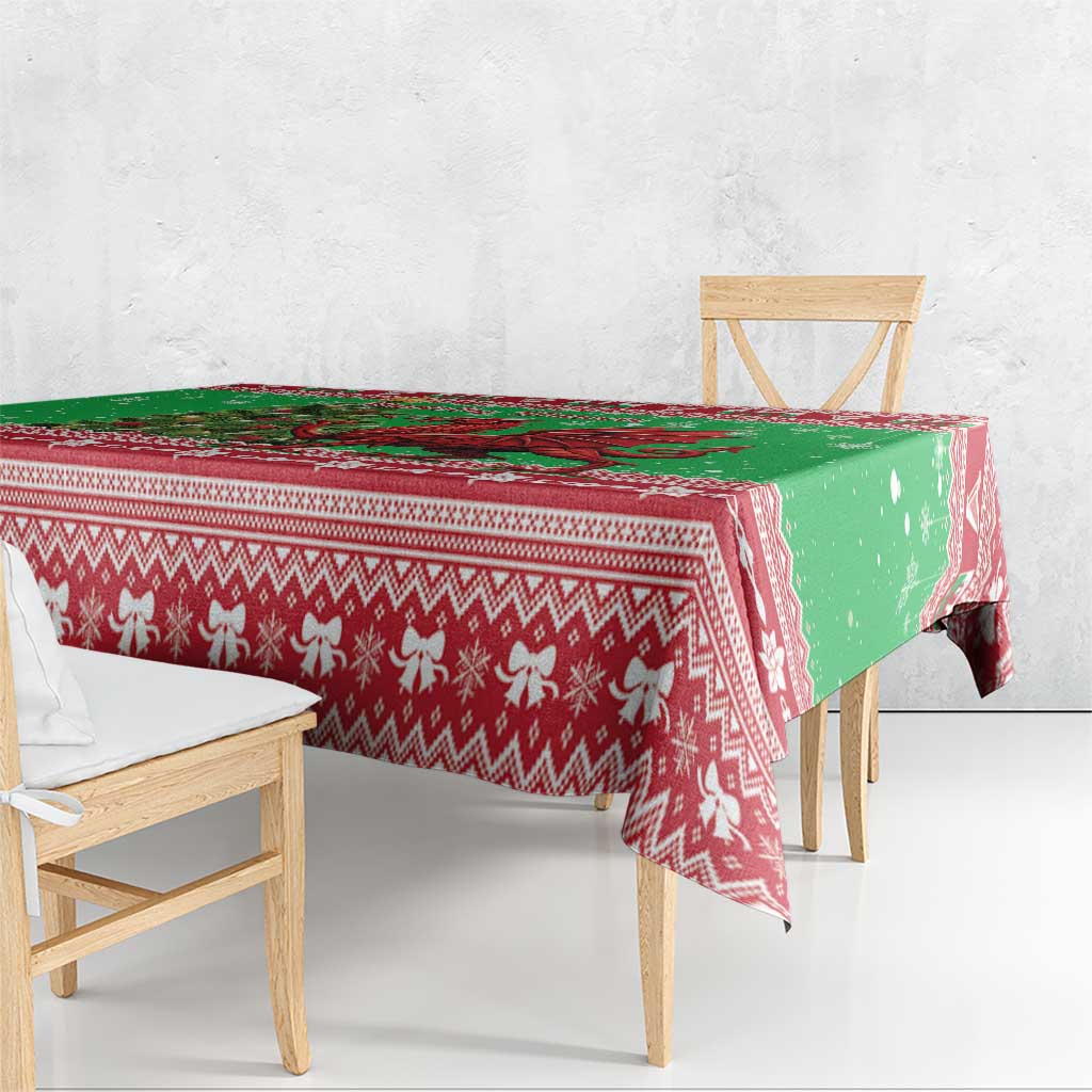 Green holiday tablecloth with red zigzag and reindeer motifs, draped over chairs