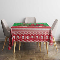 Green holiday tablecloth with red Nordic pattern and snowflakes, centered on dining table