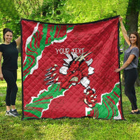 Red Wales quilt spread out with Welsh dragon emblem and custom text, framed by green/white