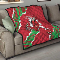 Red Wales quilt draped over a sofa with Welsh dragon graphic and custom text