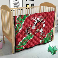 Red Wales quilt on a baby bed with Welsh dragon graphic and custom text, green/white accents