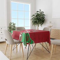 Red personalized Wales tablecloth with green dragon print draped over dining table