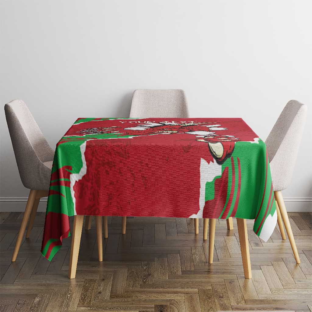 Red personalized tablecloth with green Welsh dragon print, placed on dining table