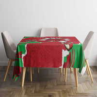 Red personalized tablecloth with green Welsh dragon print, placed on dining table