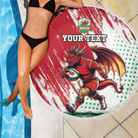 Red round beach blanket with white fringe, Wales dragon mascot and green polka-dot border