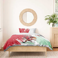 Red and white Welsh dragon bedding set with custom text, duvet spread and two pillows on bed