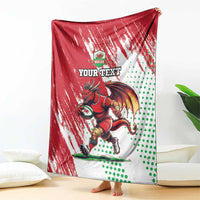 Red and white Wales rugby mascot blanket featuring a running dragon and green dot pattern