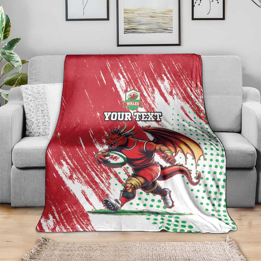 Red, white and green Wales rugby mascot blanket draped over a sofa with dragon artwork