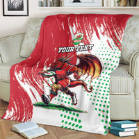 Red, white and green Wales rugby mascot blanket with dragon graphic and diagonal streaks