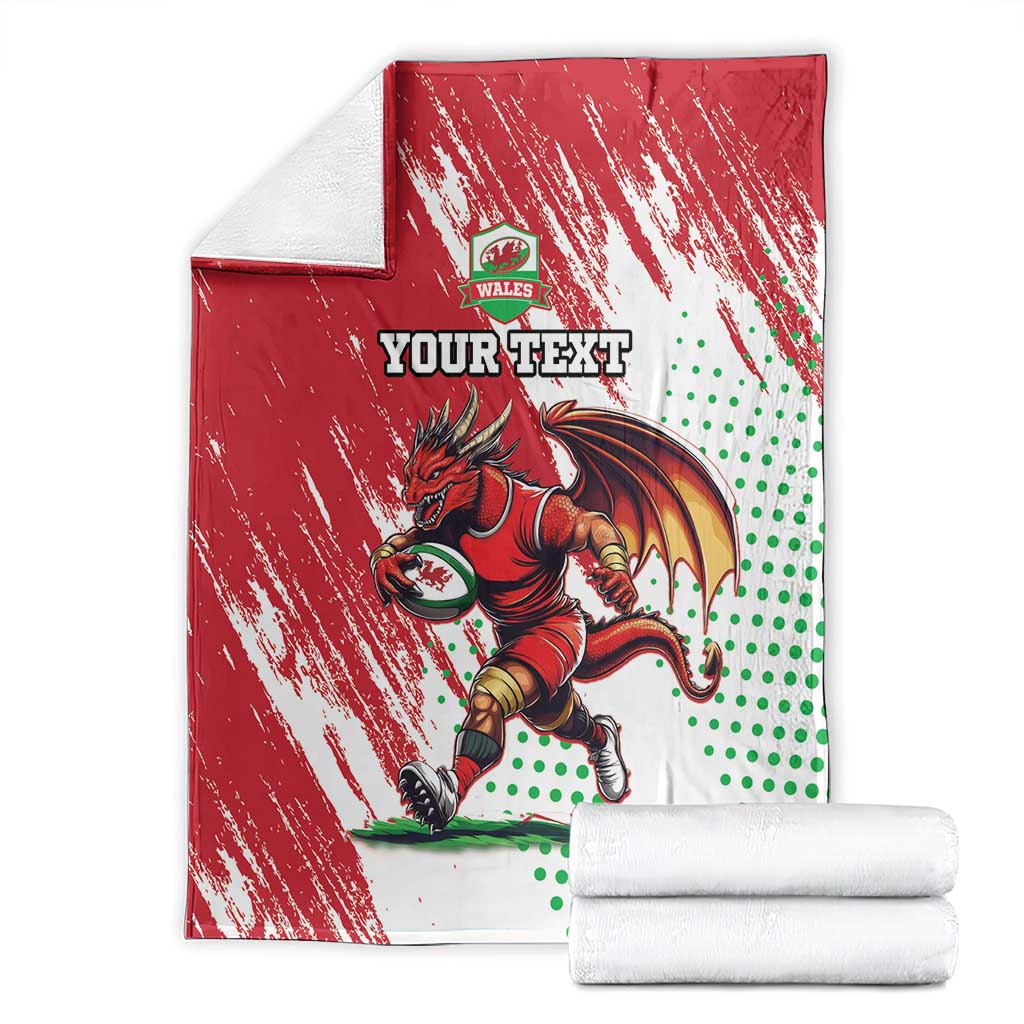 Red and white Wales rugby mascot blanket with dragon graphic, plus folded white stacks
