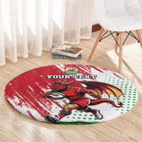 Red round rug with Welsh dragon mascot, green dot pattern, and “YOUR TEXT” text