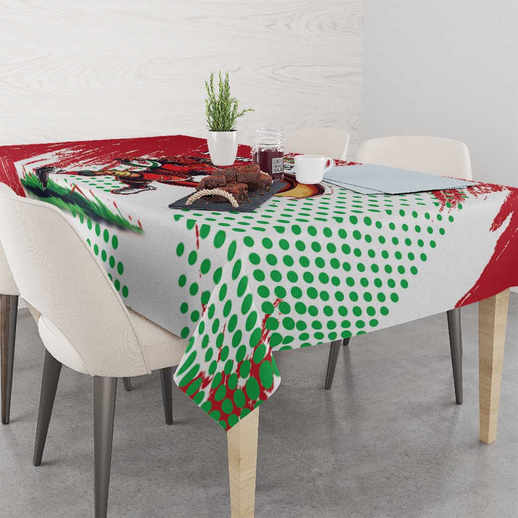 Custom tablecloth draped over dining table with Welsh dragon print and green dots.