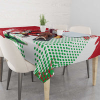 Custom tablecloth draped over dining table with Welsh dragon print and green dots.