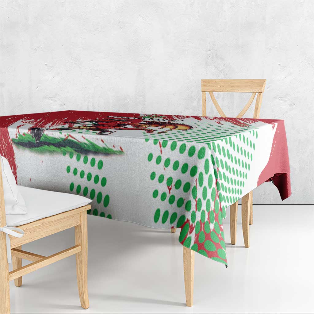 Red and white tablecloth with Welsh dragon artwork and green dot design on corner.
