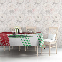 Red and white custom tablecloth with Welsh dragon mascot and green dotted pattern over table.