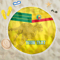 Yellow round beach blanket with leopard graphic, flag stripes, white fringe, and 'YOUR TEXT'.