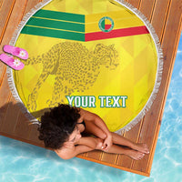 Yellow round beach blanket with leopard and flag stripes, fringed edge, and 'YOUR TEXT'.