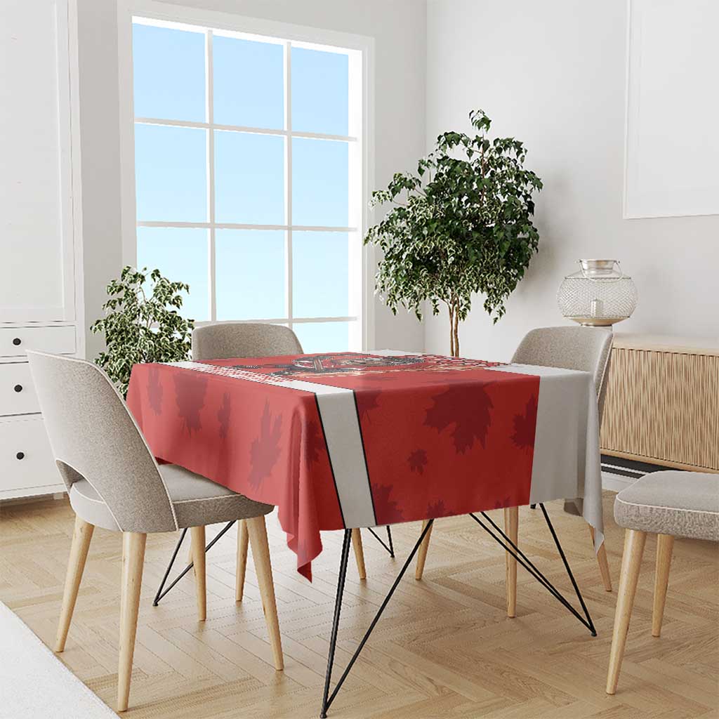Red hockey-themed tablecloth with maple leaf pattern and dark stripe runner on a dining table.