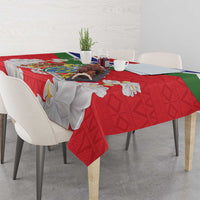Red tablecloth featuring Gambia coat of arms and white flower motifs
