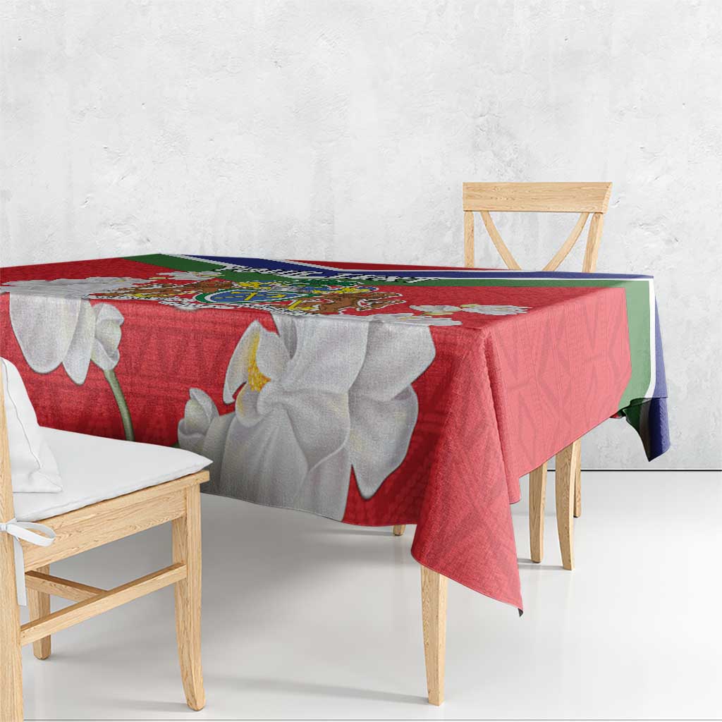 Red Gambia coat of arms tablecloth draped over dining benches