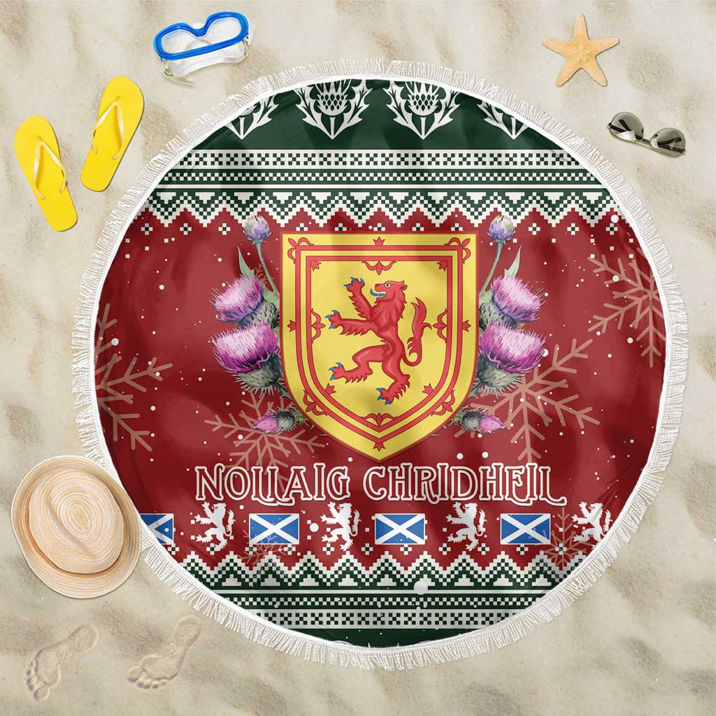 Round red Christmas beach blanket with Scottish crest, thistle, and fringed white edge.