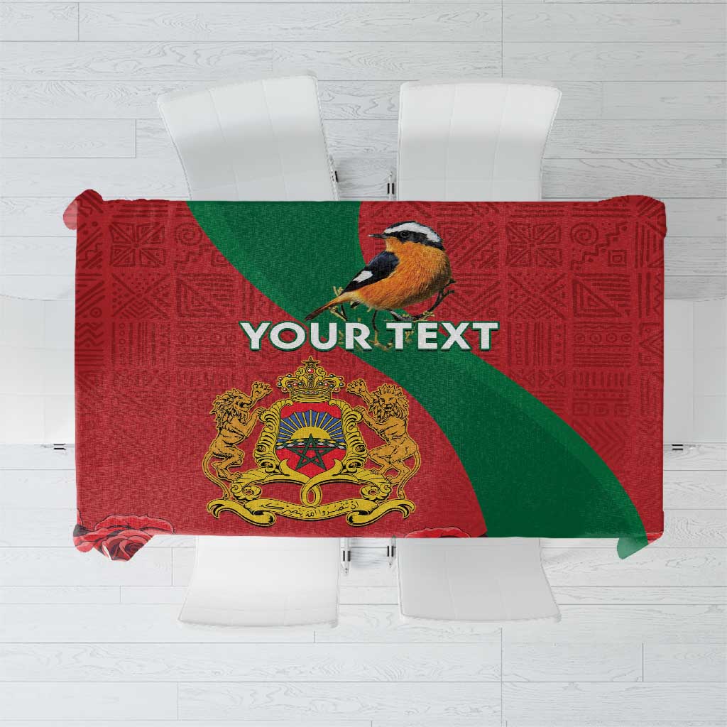 Personalised red and green tablecloth with bird, coat of arms, and 'YOUR TEXT'.