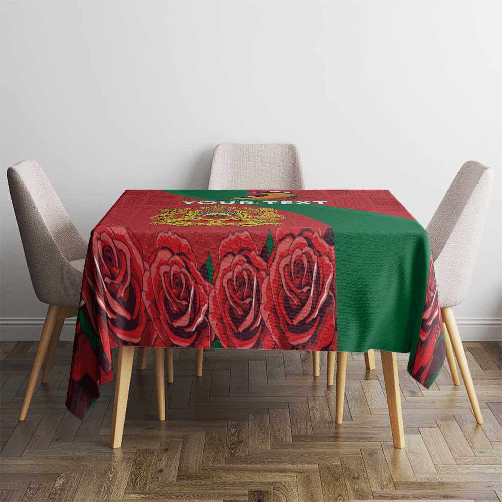 Square red tablecloth with green side panel and bold rose motif print.
