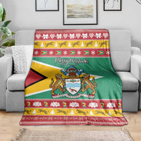 Guyana Christmas blanket on sofa: green flag center, coat of arms, and holiday border.