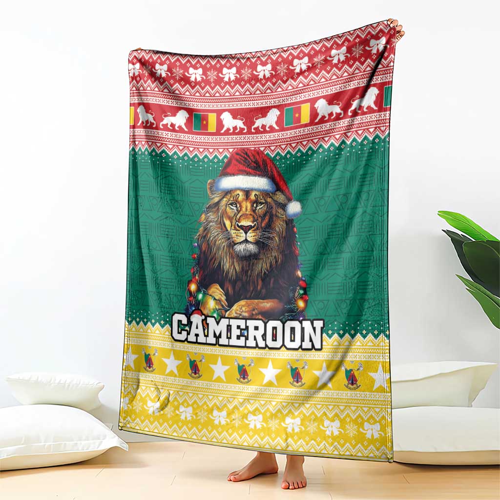 Green blanket with red top border, lion in Santa hat, and 'CAMEROON' lettering