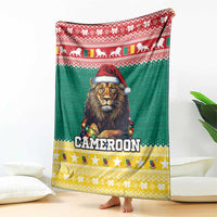 Green blanket with red top border, lion in Santa hat, and 'CAMEROON' lettering