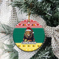 Green ceramic round Christmas ornament with lion in Santa hat and gold hanging loop on tree.