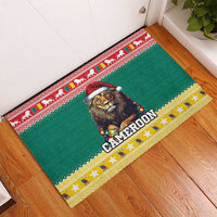 Green rubber doormat in corner with lion Santa hat, CAMEROON lettering, red yellow border