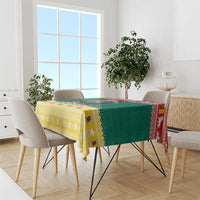 Festive green tablecloth with star border, yellow patterned trim, and red decorative accents