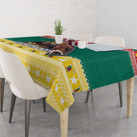 Green and yellow Christmas tablecloth with patterned borders and corner hanging drop
