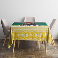 Yellow patterned Christmas tablecloth with green stripe and red decorative edge