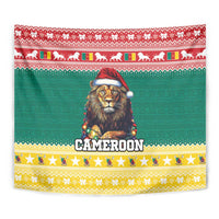 Green Christmas tapestry with central lion in red Santa hat and Cameroon lettering