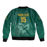 Green bomber jacket with ribbed hem, back text "YOUR TEXT 15", and floral cricket design