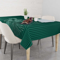 Green cricket tablecloth with striped leaf motif, draped over table corner