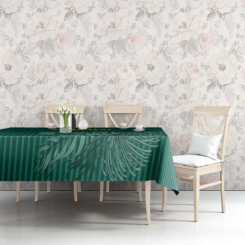 Green cricket tablecloth on table with fern-like leaf stripe design