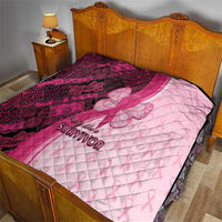 Quilted pink and maroon blanket with “Survivor” text and large ribbon-butterfly emblem